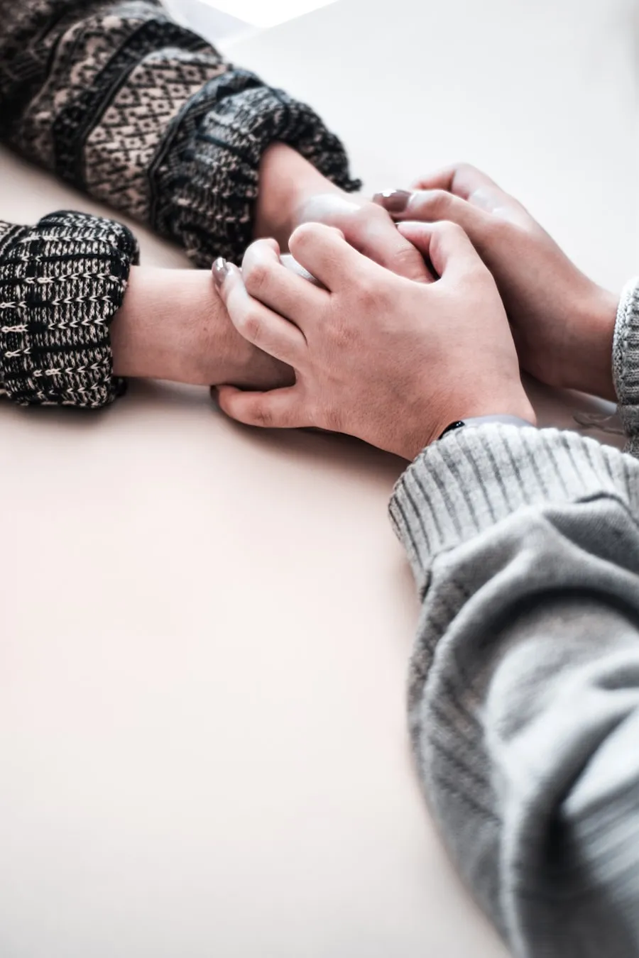 Two people holding hands warmly