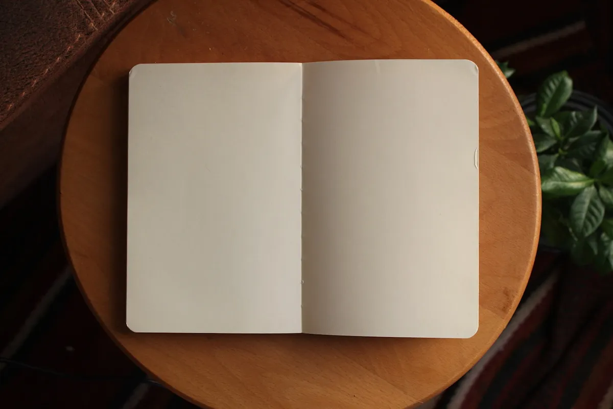 An open notebook on a warm wooden table
